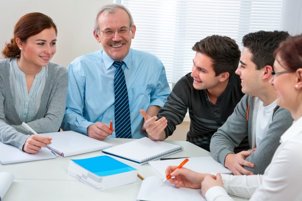 School staff talking together around a table